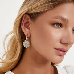 Earrings Coiné showcasing gold-plated brass design with antique coin texture worn by a model.