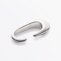 Earcuff Clip made of brass with a polished finish, showcasing minimalist design and fluid strength.