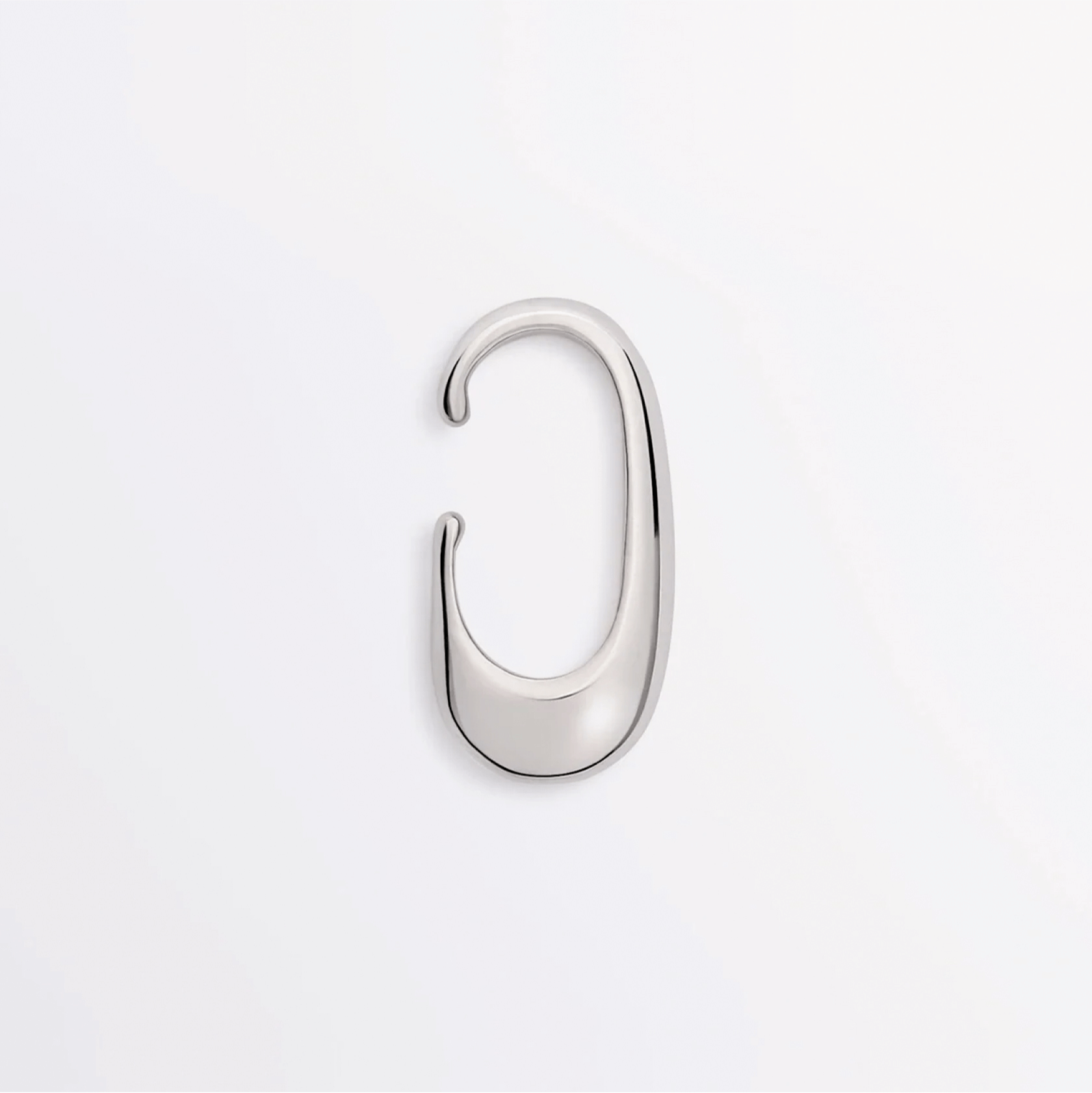 Earcuff Clip made of brass with a sleek, polished curve design for minimalist elegance.