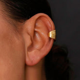 Earcuff Stria gold-plated brass ear cuff earring showcasing sleek parallel lines on the ear.