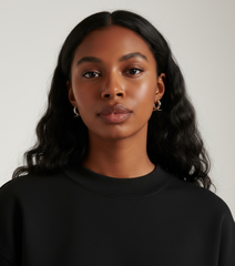 Model wearing Earrings Flux, elegant brass earrings plated with platinum, showcasing a graceful design.