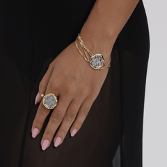 Close-up of hand adorned with Bracelet Coiné and matching ring, showcasing vintage coin details in gold settings.