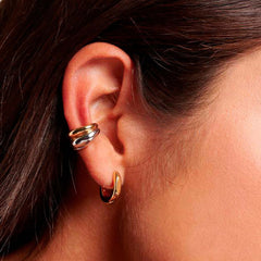 Earcuff Dual set showcased on ear, featuring polished gold and mirror-finish silver earcuffs, designed for non-pierced wear.