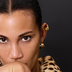 Close-up of model showcasing Earcuff Stria, a gold-plated cuff earring with sleek lines.