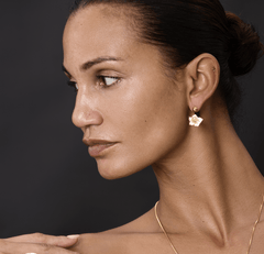 Earrings Iris 2 showcased on model, featuring a flower design in gold and enamel, highlighting elegance and nature-inspired beauty.