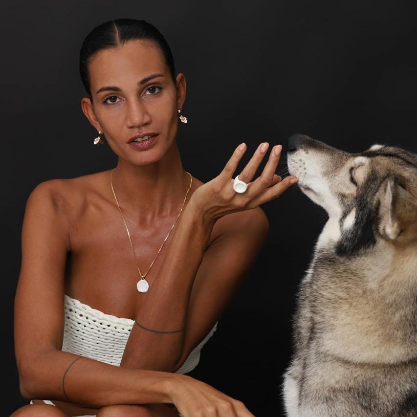 Earrings Iris 2 displayed with a model featuring elegant jewelry and a beautiful dog, highlighting nature-inspired design.