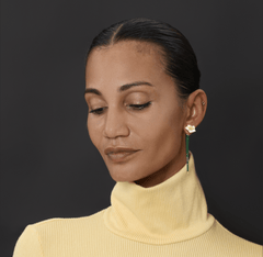 Earrings Iris worn by a model, showcasing delicate brass and gold-plated design with an elegant floral motif.