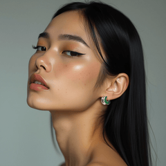 Earrings Verdant worn by a model, showcasing bold crescent design in deep green with polished silver accents.