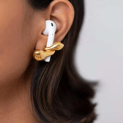 Earrings Looppods elegantly holding AirPods, showcasing golden brass design and minimalistic style.