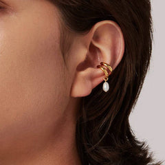 Close-up of Earcuff Drop in gold plating with a freshwater pearl, showcasing elegant design and minimalistic style.