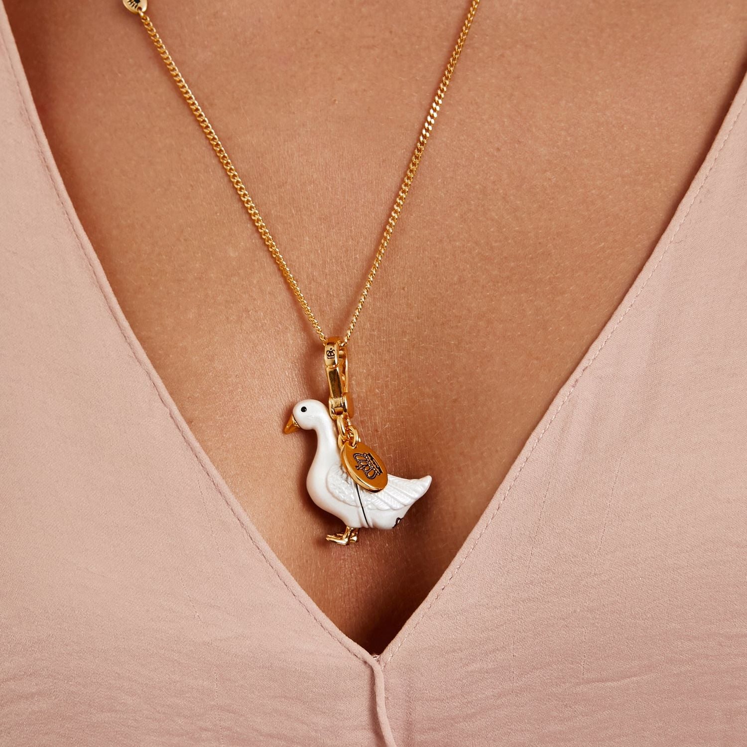 Necklace Goose featuring a playful gold-plated charm with glossy enamel finish worn on a delicate chain.