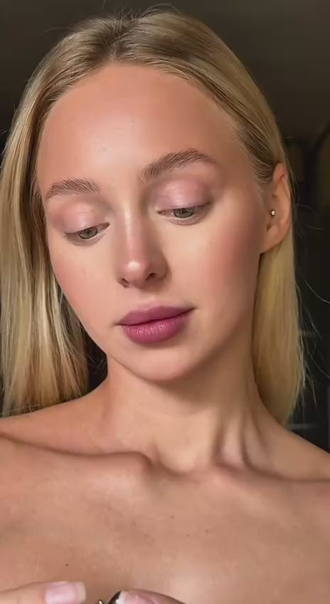 Close-up of a woman with blonde hair showing natural makeup, ideal for showcasing Earrings Flux.