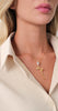 Necklace Bloom worn by a model, featuring an elegant rose pendant with polished gold finish.