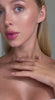 Model showcasing glowing skin and glossy lips, demonstrating beauty trends and skincare tips.